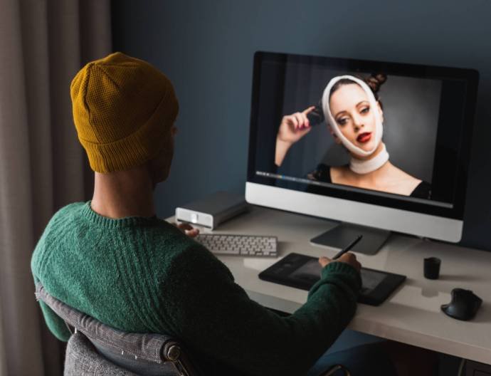 Man working at home editing pictures on computer